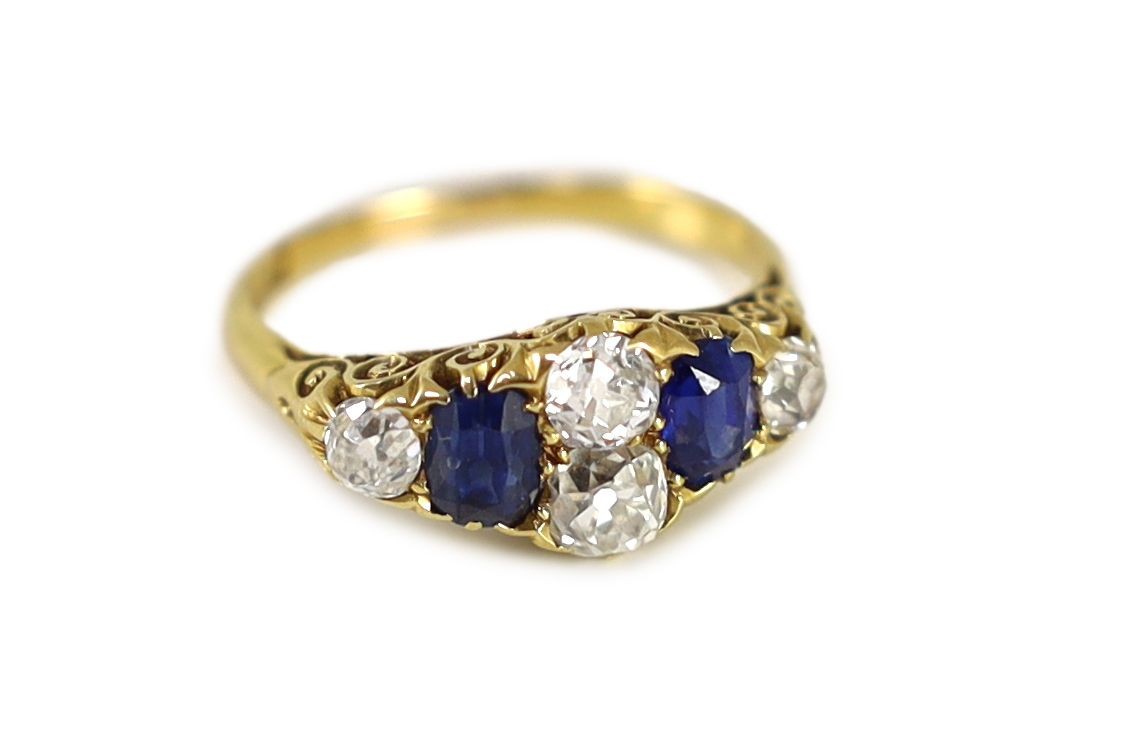 A Victorian style 18ct gold, four stone old round diamond and two stone sapphire set ring